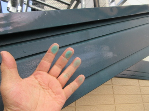 破風板塗膜の劣化を点検し、指に青い塗膜がついている画像